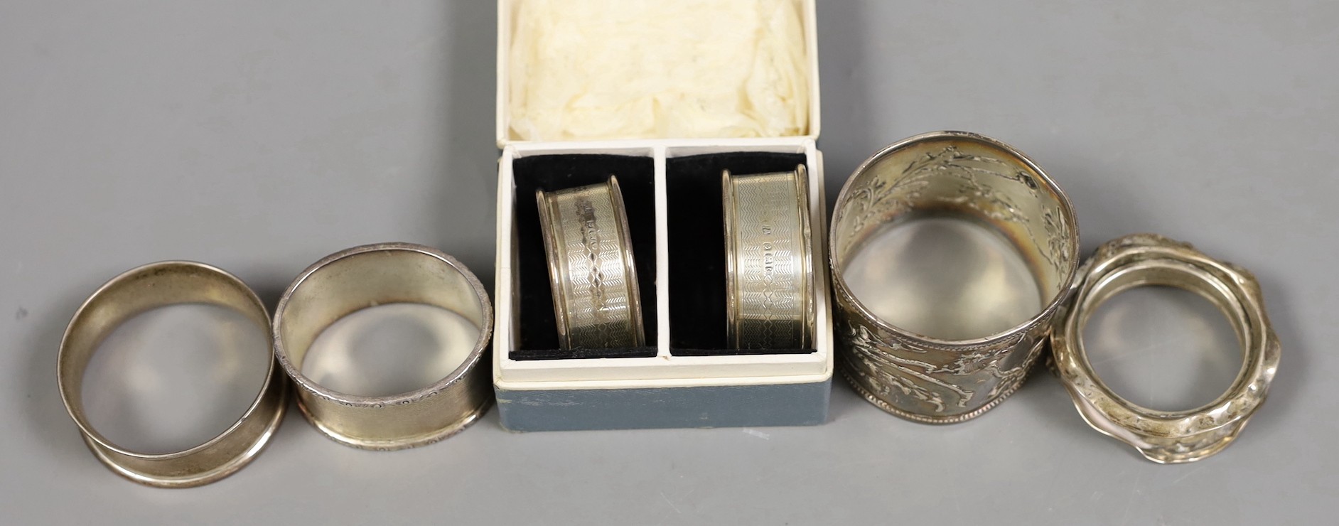 Six assorted silver napkin rings including a pair, Birmingham, 1913.